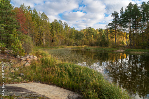 The rocky shore of Lake Ladoga in the Ladoga Skerries National Park near the village of Lumivara on a sunny autumn morning, Republic of Karelia, Russia