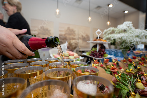 Fotografi Pouring sparkling beverage at catered celebration event.