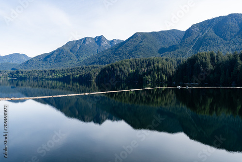 Capilano reservoir lake with reflection and mountains North Vancouver British Columbia Canada
