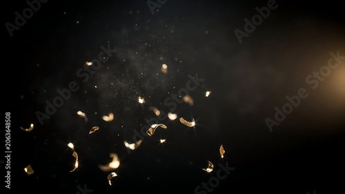 Glowing golden sparks flying through dark air with smoke