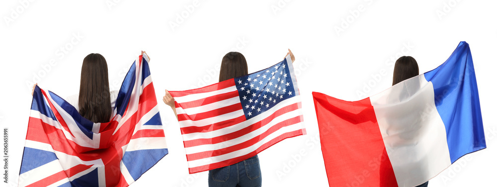 Fototapeta premium A woman joyfully waves UK, USA, and France flags while exploring vibrant places, PNG