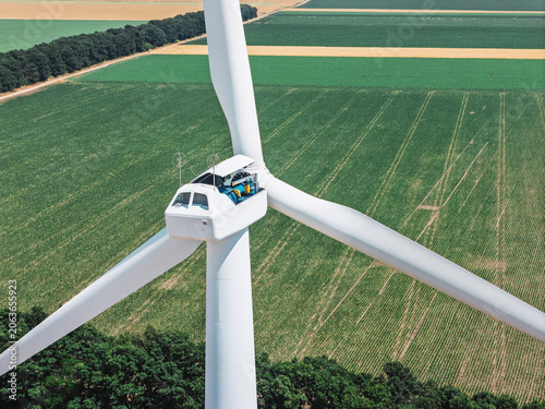 Fotografía Worker performing routine inspection inside wind turbine nacelle