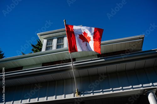 View of Canadian flag displayed on residential building.
