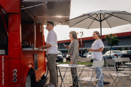 Obraz na płótnie People queuing at a food truck for street food