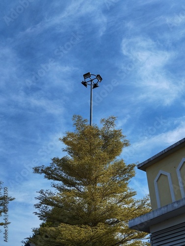 Spot-light tower on street against the blue sky background