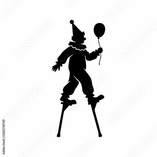 Silhouette of a clown walking on stilts holding a balloon isolated on white background
