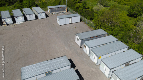 Tableau sur toile Portable cabins and construction containers are waiting on a gravel lot surround