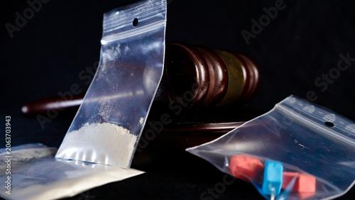 Fotografie Gavel and illegal substances, including white powder and colored pills in ziploc