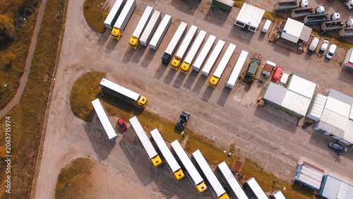 Trucks and trailers parked at depot
Aerial view of logistics warehouse yard