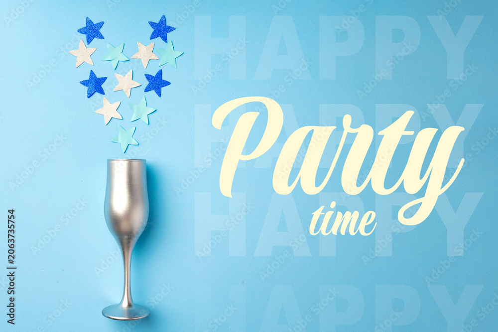 Fototapeta premium Celebrating a happy birthday with stars and a silver glass on a blue background