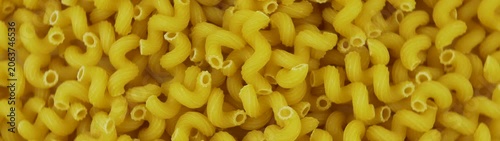 Cavatappi pasta creating a uniform full frame pattern Uncooked dry macaroni noodles ready for cooking.
