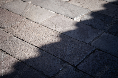 Photography Strong architectural shadow falling across stone pavement in Taipei