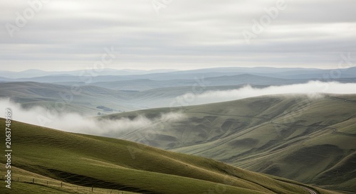 Rolling Hills Covered in Gentle Mist Under Cloudy Skies