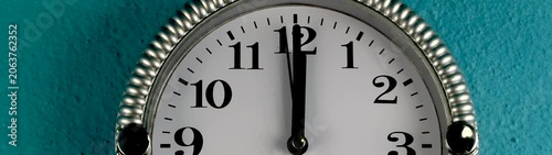 Clock hands pointing to noon or midnight.