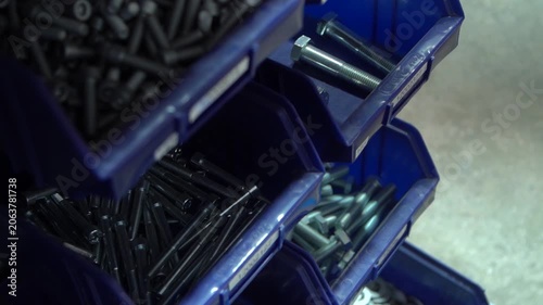 Screw nut organizer different sizes in repair workshop on factory plant.