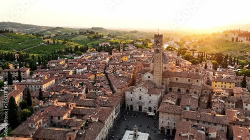 Aerial View of a Charming Ancient Town at Sunset Surrounded by Rolling Hills and Lush Vineyards, Showcasing Historic Architecture and Vibrant Color Palette