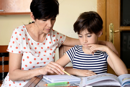 Child solving problems attentively. Quiet home setting with educational activity underway