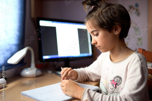 Dedicated student improves penmanship during quiet evening practice at home desk