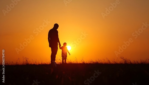 silhouette of a father  and son running on the sunset