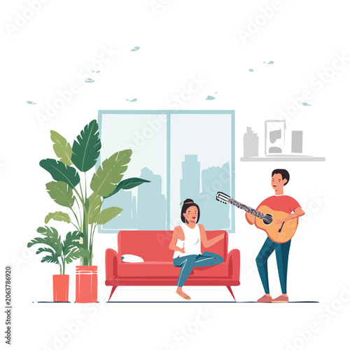 Couple enjoying music at home with guitar and plants