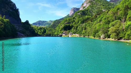 4K Drone Pullback Over Turquoise Mountain Reservoir and Forest