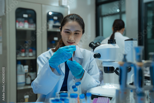 Obraz na płótnie Life scientists researching in a modern lab,  biotech innovation, medical analysis, DNA research, and healthcare science in a clean