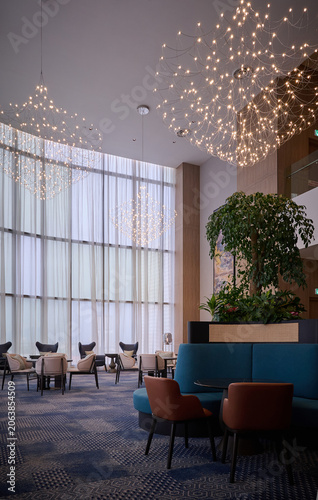 Luxury hotel lobby with modern chandeliers and lounge seating