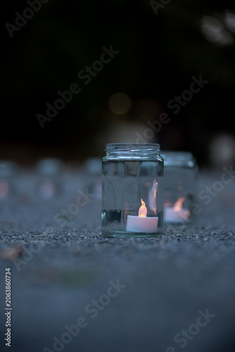 Single LED Candle in a Glass Jar at Night
