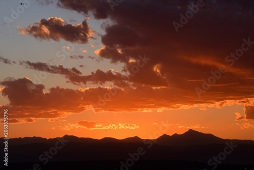 colorful summer sunset  over long's peak and  the front range of the colorado rocky mountains, from broomfield,  colorado 