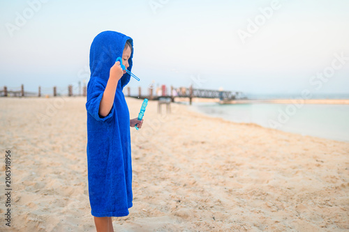 4-Year-Old Boy in Blue Towel at Beach with Bubbles at Dusk