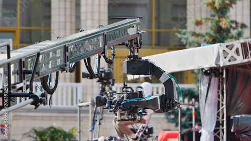 Professional video camera mounted on a large jib crane during a production