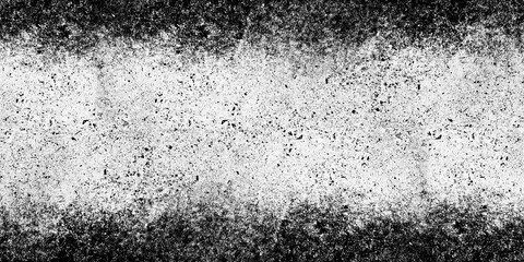 High-contrast black and white grunge texture background featuring  dirty distressed cement wall effect with heavy dark speckles and vignetted borders
