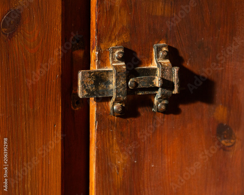 Obraz na płótnie Old iron door bolt lock on an old brown wooden door close-up