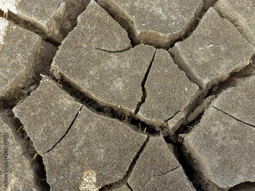 Schilderij op canvas Close up of cracked soil texture caused by prolonged drought