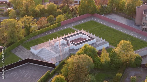 Aerial circling shot of Roman Temple replica during golden hour, Tongeren