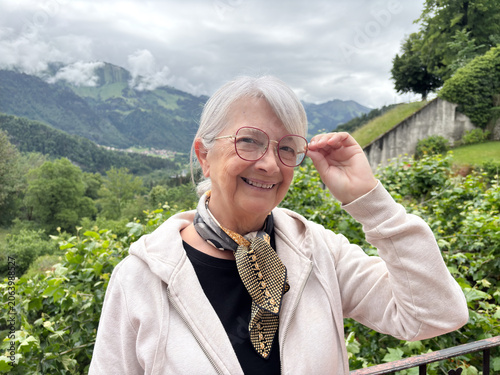 Cuadro en lienzo Smiling senior woman enjoying an active retirement journey in nature, wearing gl