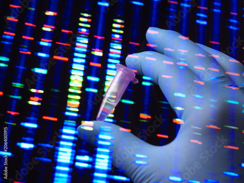 Gloved hand holding a test tube against a DNA sequencing background with blue and red bars.