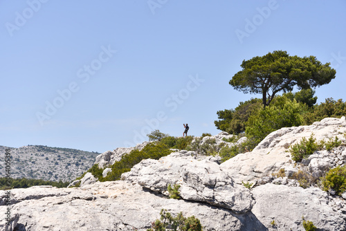 Hiker Amid French Riviera Mountains Along the Trail to Calanque d’En-Vau During Summer in France