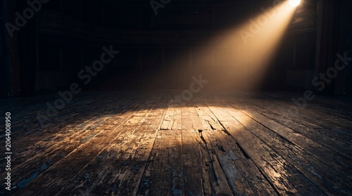 Wooden floorboards illuminated by a single spotlight in a darkened room