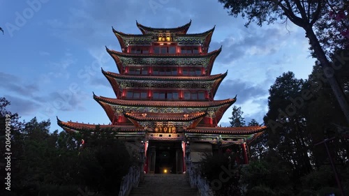 Lijiang, China : Tilt down footage of Chinese pagoda at the top of the Shizi Mountain Wangulou Scenic Area in Lijiang at twilight in Yunnan province in China