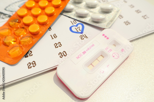 Birth control pills for women and pregnancy test, conception date on the calendar, due date, ovulation day, fetus, pregnancy, birth control and fertility increase.