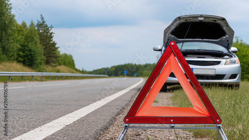 Fotografi Car breakdown on rural highway, Emergency warning triangle on asphalt, Broken ca