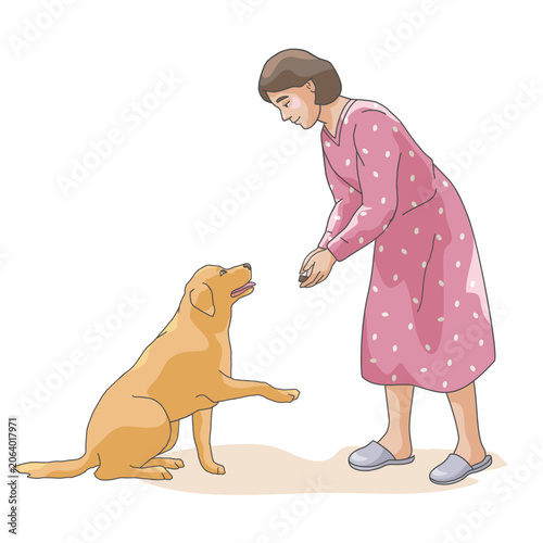 Obraz na plátně Pet owner teaching obedience commands and rewarding her dog with a treat