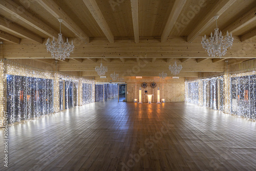 Empty ballroom with fairy lights and chandeliers for event