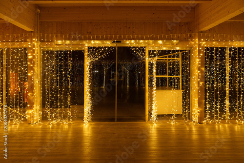 Golden fairy light curtain decorating a festive indoor doorway