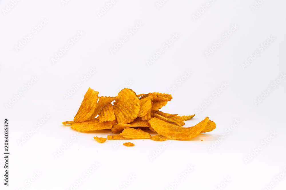 Fototapeta premium A small pile of ridged potato chips isolated on white background