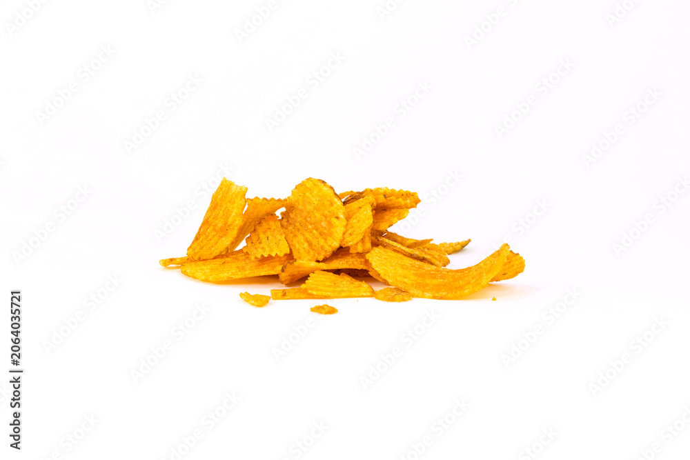 Fototapeta premium A small pile of crispy ridged potato chips seasoned with spices, isolated on white background