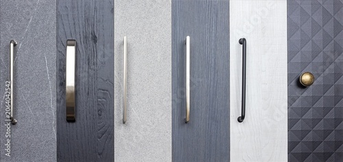 Collection of cabinet door handles in different styles and finishes in a home improvement setting
