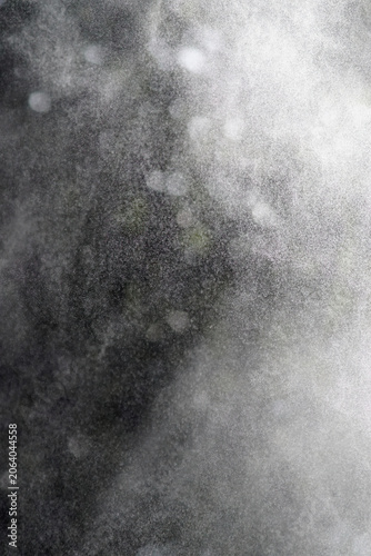Mist or droplets in the air with forest background