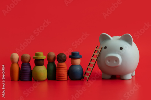 Quadro su tela A blue piggy bank and a group of symbolic people on a red background